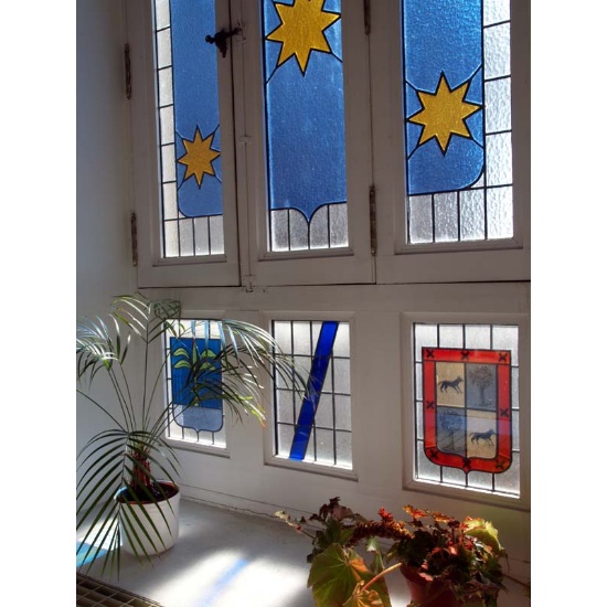 Stained glass window with the coat of arms of the USC founders